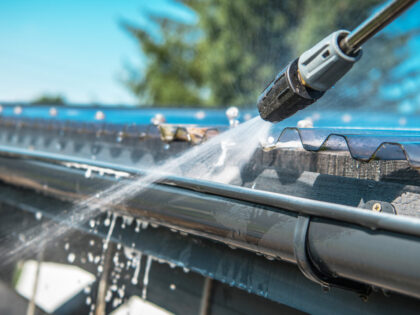 Spring,Rain,Gutters,Cleaning,Using,Pressure,Washer.,Closeup,Photo.